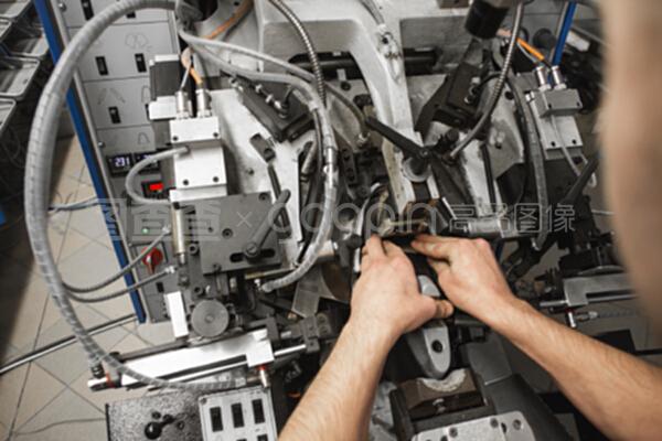 男人用特殊的機械工具制鞋。鞋廠的輸送機,有鞋底和鞋底。